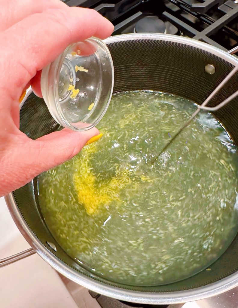 Adding lemon zest to lemonade.