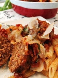 Meatballs with pasta in a serving dish.