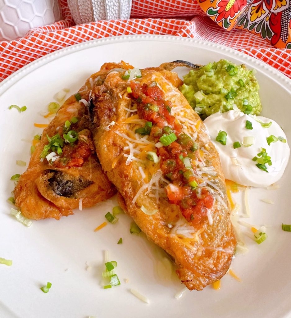 Chile Relleno's served with salsa, guacamole, sour cream, and cheese.