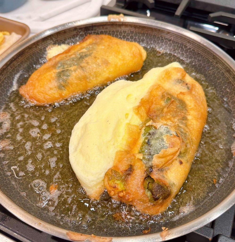 Batter squished out the side of cooked chile relleno.