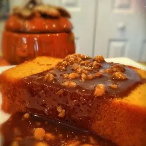 Slice of Pumpkin Pound cake with Walnut Caramel Sauce on a dessert plate.