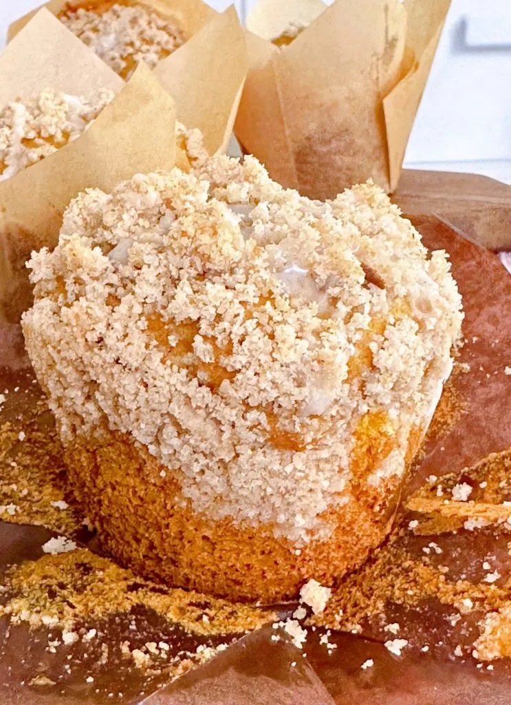 Close-up photo of a pumpkin muffin out of the muffin liner.