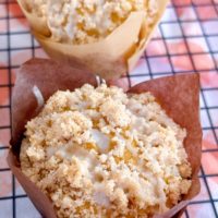 Close-up of Pumpkin Streusel Muffin in a baking liner on a cooling rack.