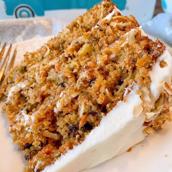 Slice of Carrot Cake on a dessert plate with a fork.