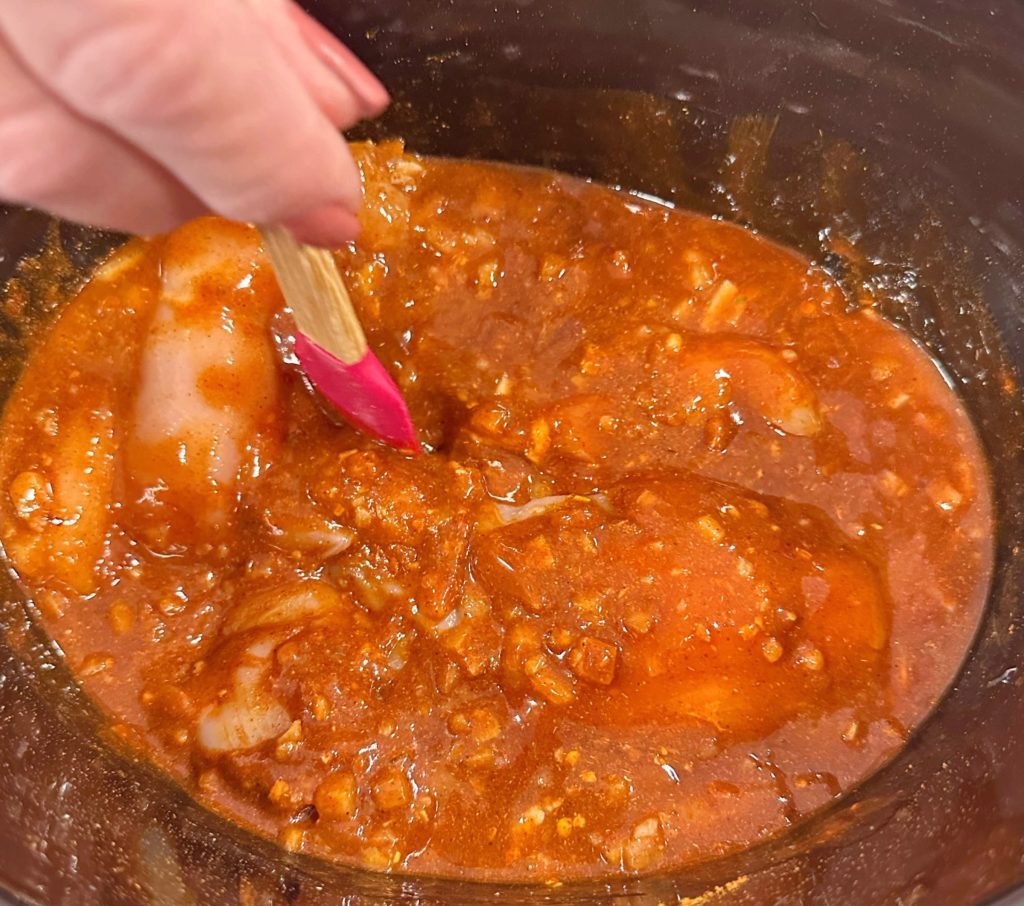 Mixing in all the enchilada sauce and chicken broth with the seasonings.