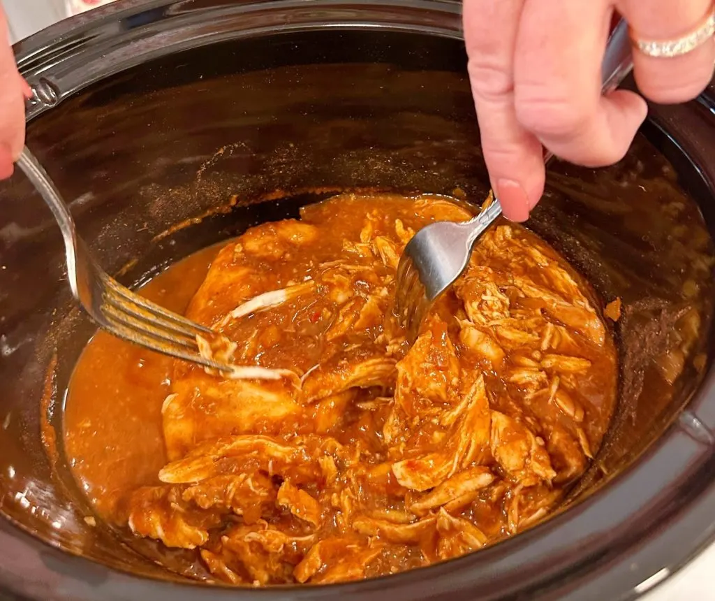 Shredding chicken in the slow cooker.