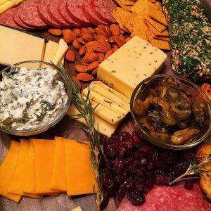 a beautiful cheese board with assorted cheese.