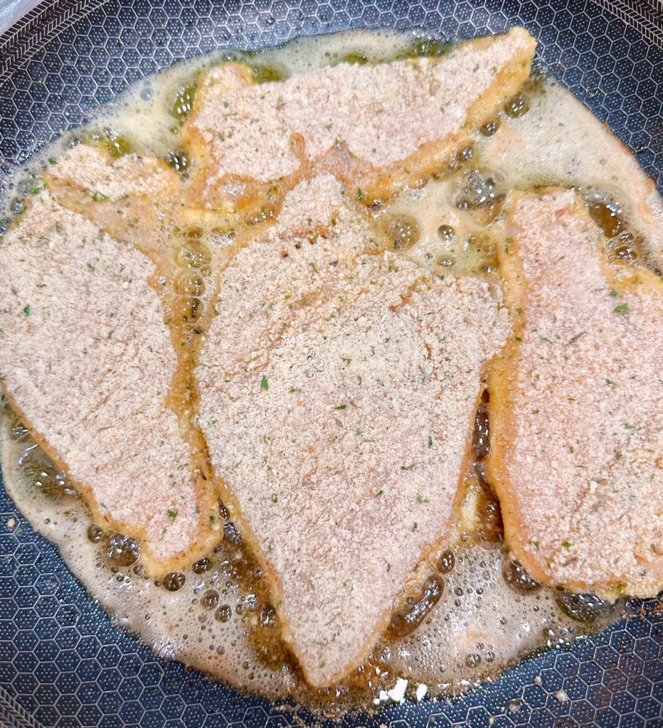 Cooking Chicken breast in a large skillet with olive oil and butter.