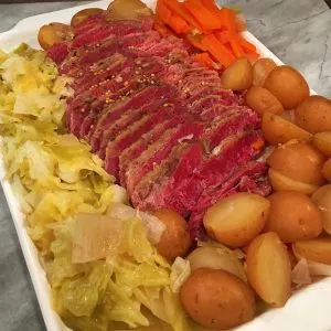 Platter full of corned beef, cabbage, potatoes and carrots.