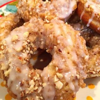 Stack of Crumb Donuts on a polka dot plate.