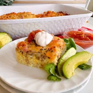 Serving of Breakfast Casserole with sour cream and salsa.