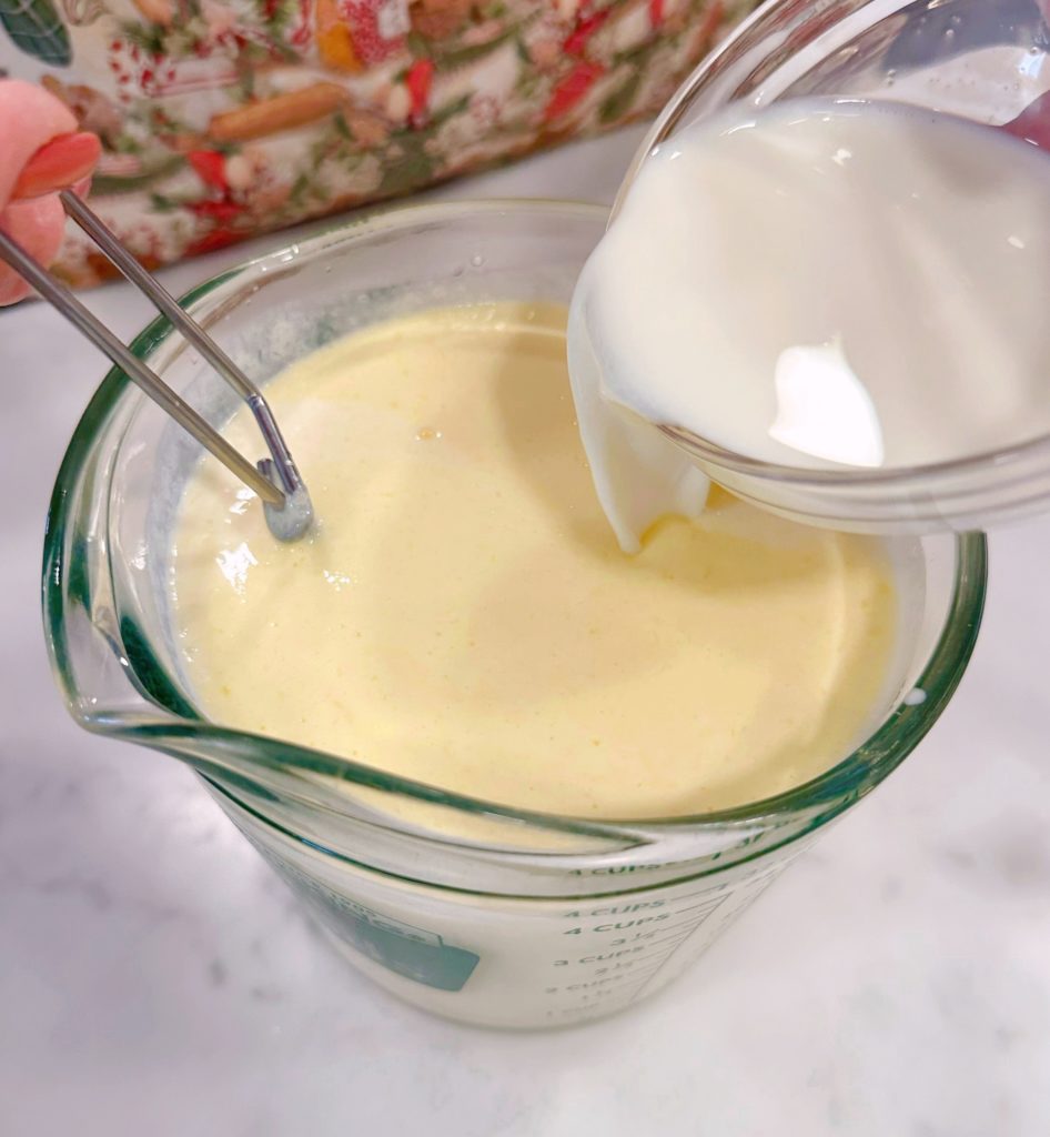 wet ingredients being whisked together in a large measuring cup.