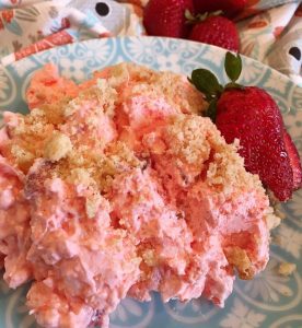 Pretty Teal Plate with a serving of Strawberry Pineapple Fluff and a sliced strawberry garnish