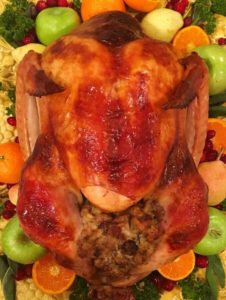 Turkey on a platter with stuffing and garnish