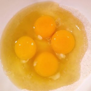 Eggs added to sugar and flour