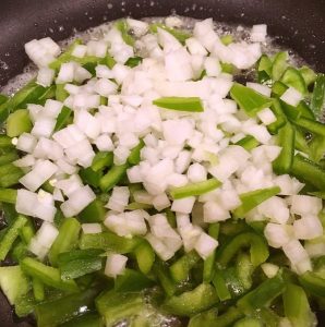 peppers and onions in skillet