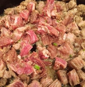 Seasoned Beef Fajita seasoned skirt steak sizzling in pan