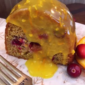 Cranberry Orange Bundt Cake slice with warm Orange Butter Glaze