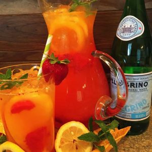 Strawberry Mango Lemonade in a pitcher and a glass