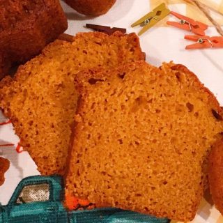 Two slices of moist pumpkin bread on a mat