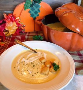 Butternut Pumpkin Cream Soup with croutons and garnish ready to eat