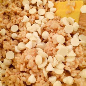 Adding white chocolate chips to rice krispie mixture