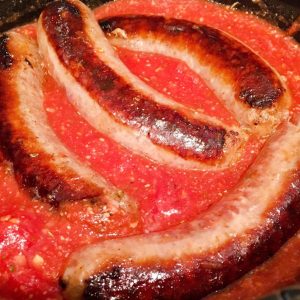 Adding browned sausage to the sauce