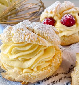 Close-Up Photo of a Cream Puff with powder sugar.