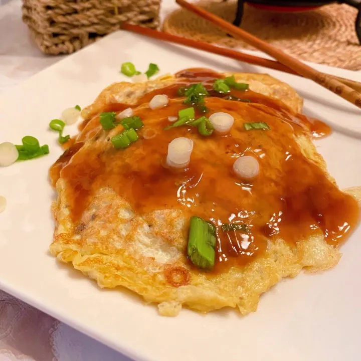 Easy Egg Foo Yung on a plate with gravy.