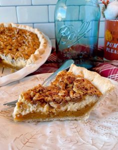 Pecan Caramel Cheesecake Pie on a plate ready to eat.