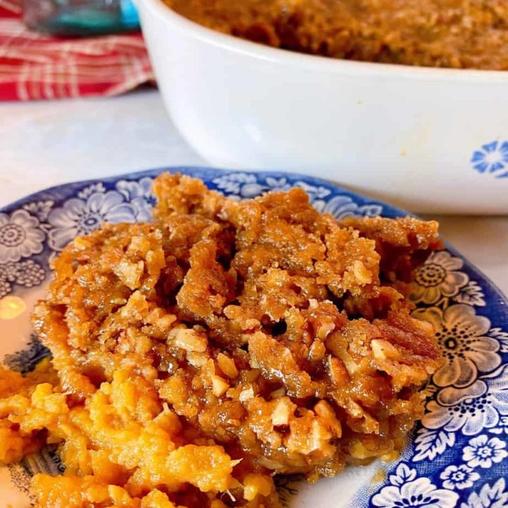 Blue and White plate with Sweet Potato Pecan Casserole on the plate.