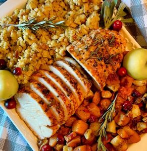 Over head photo of sliced roast with stuffing and butternut squash.