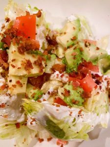 Adding toppings to salad wedges