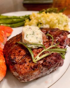 Pan-seared Filet Mignon with Herbed Butter on a serving plate.