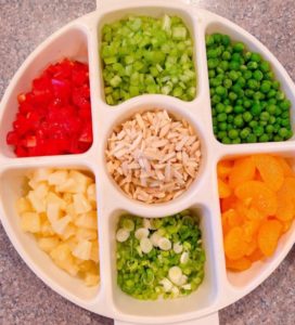 Toppings for Haystacks in a divided container.