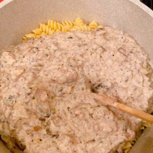 Adding Ground Beef Gravy to Pasta.