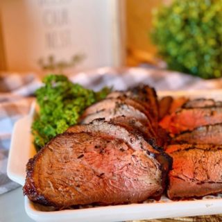 Sliced Grilled Tri-tip on a serving platter.