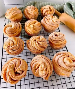 Cruffins on a baking sheet cooling.