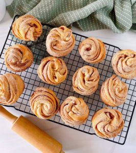 Bakers cooking rack loaded with Cinnamon Sugar Cruffins.