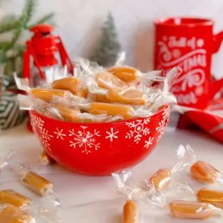 Homemade Caramels wrapped and in a red candy dish.