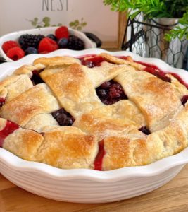 Triple Berry Deep Dish Galette up close with fresh berries in a basket in the background.