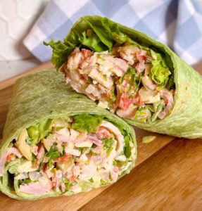 Italian Grinder Sandwich Wrap on a cutting board.