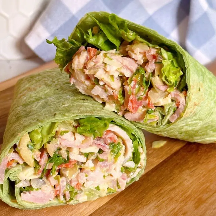 Italian Grinder Sandwich Wrap on a cutting board.