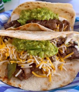 Steak Fajitas on a paper plate.