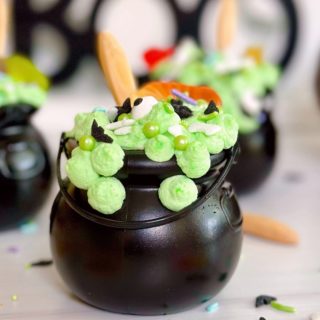 Black Cauldron Dessert Cups close-up with sprinkles and gummy worms.