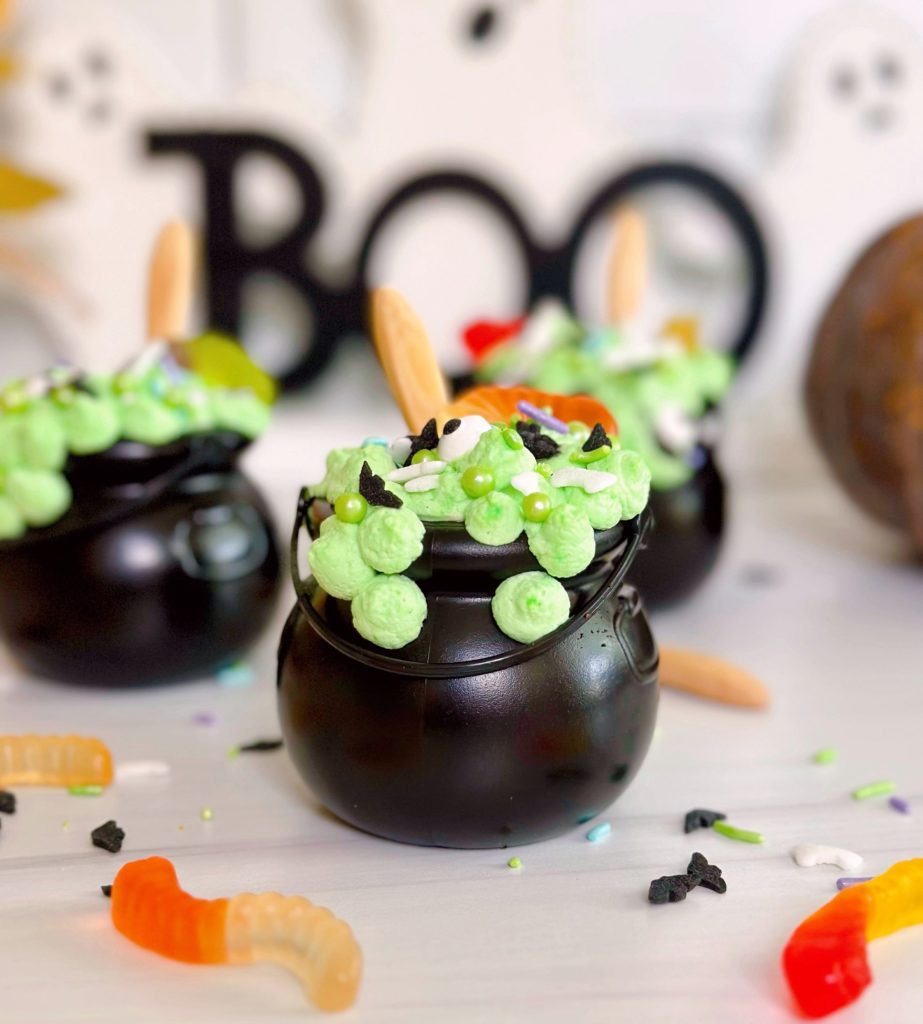 Spooky Witches Pudding Cups with gummy worms and halloween decor.