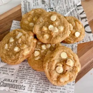 Pile of White Chocolate Chip Macadamia Nut Cookies on a cutting board.