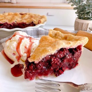 Slice blackberry Pie with vanilla ice cream.