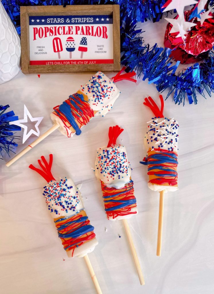 Firecracker Swiss Roll Cake Pops on a table decorated and ready to eat!