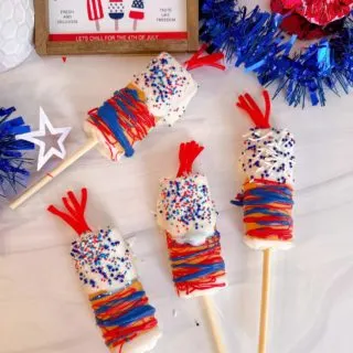 Firecracker Swiss Roll Cake Pops on a table decorated and ready to eat!